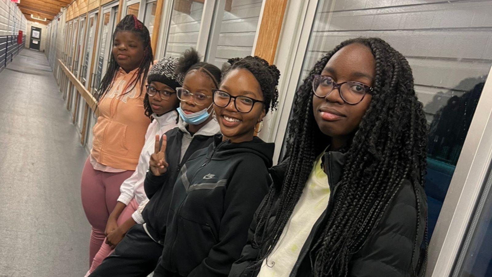 A group of the Village Blog Gurls pose for a photo op at an indoor facility