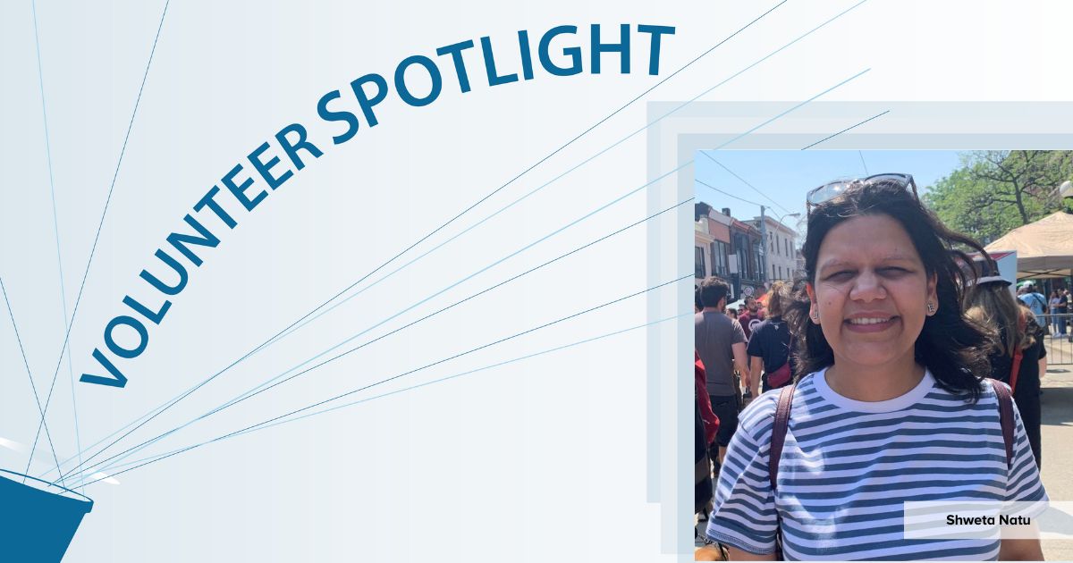 The volunteer is standing in a busy city street on her travels.