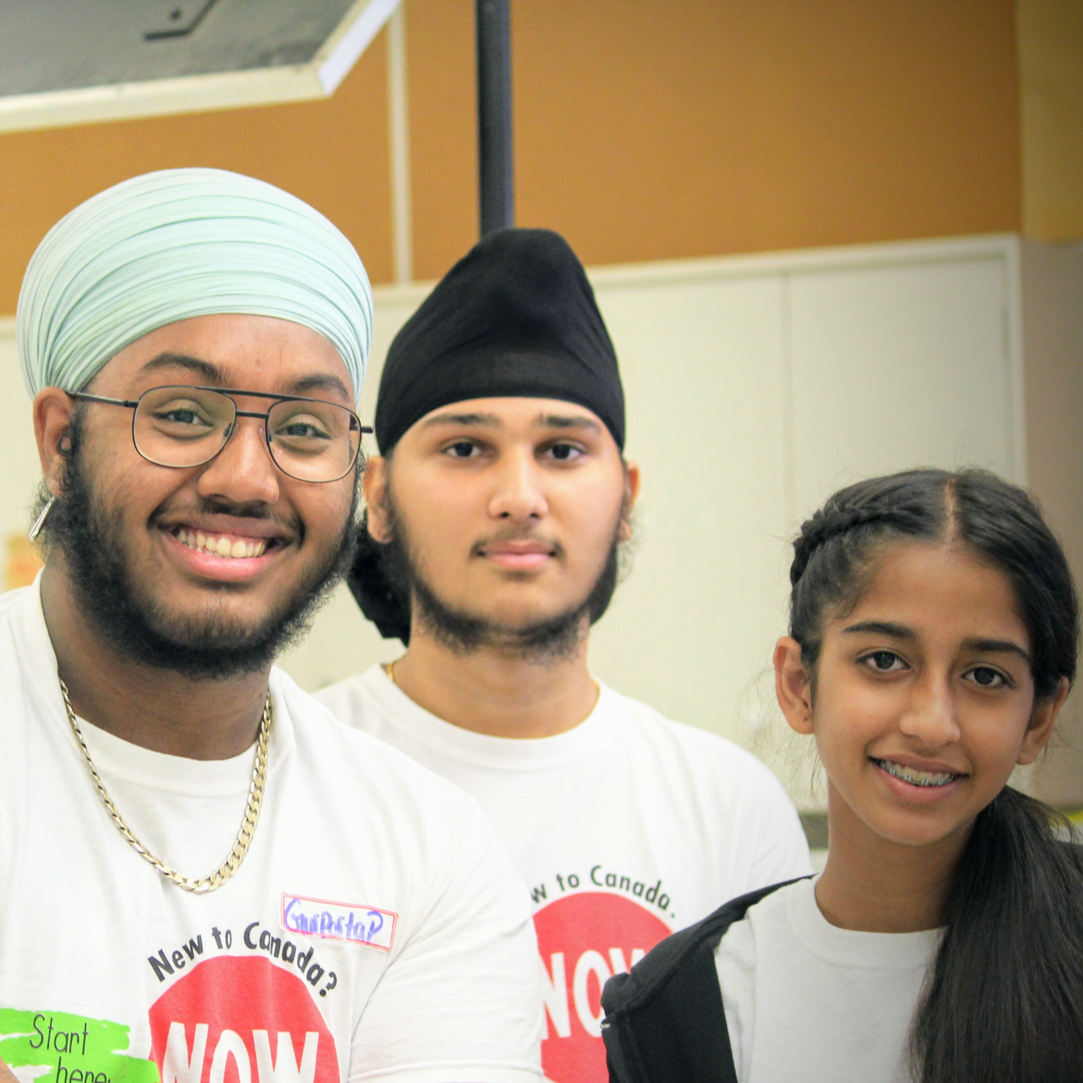 Three young people smiling.