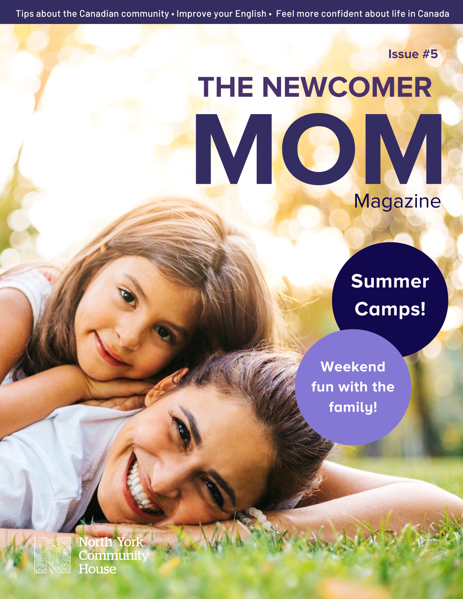 A parent and child laying on the grass in the park