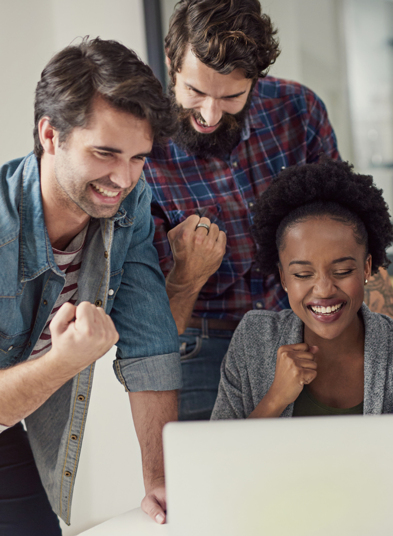 A group of individuals gathered around a laptop, engaged in discussion and collaboration.