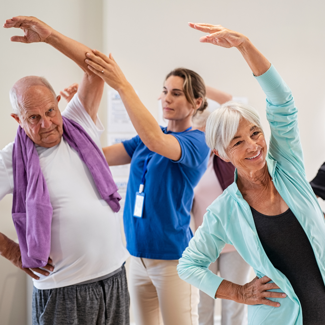 Two older adults following and participating in exercises together in a vibrant gym environment.