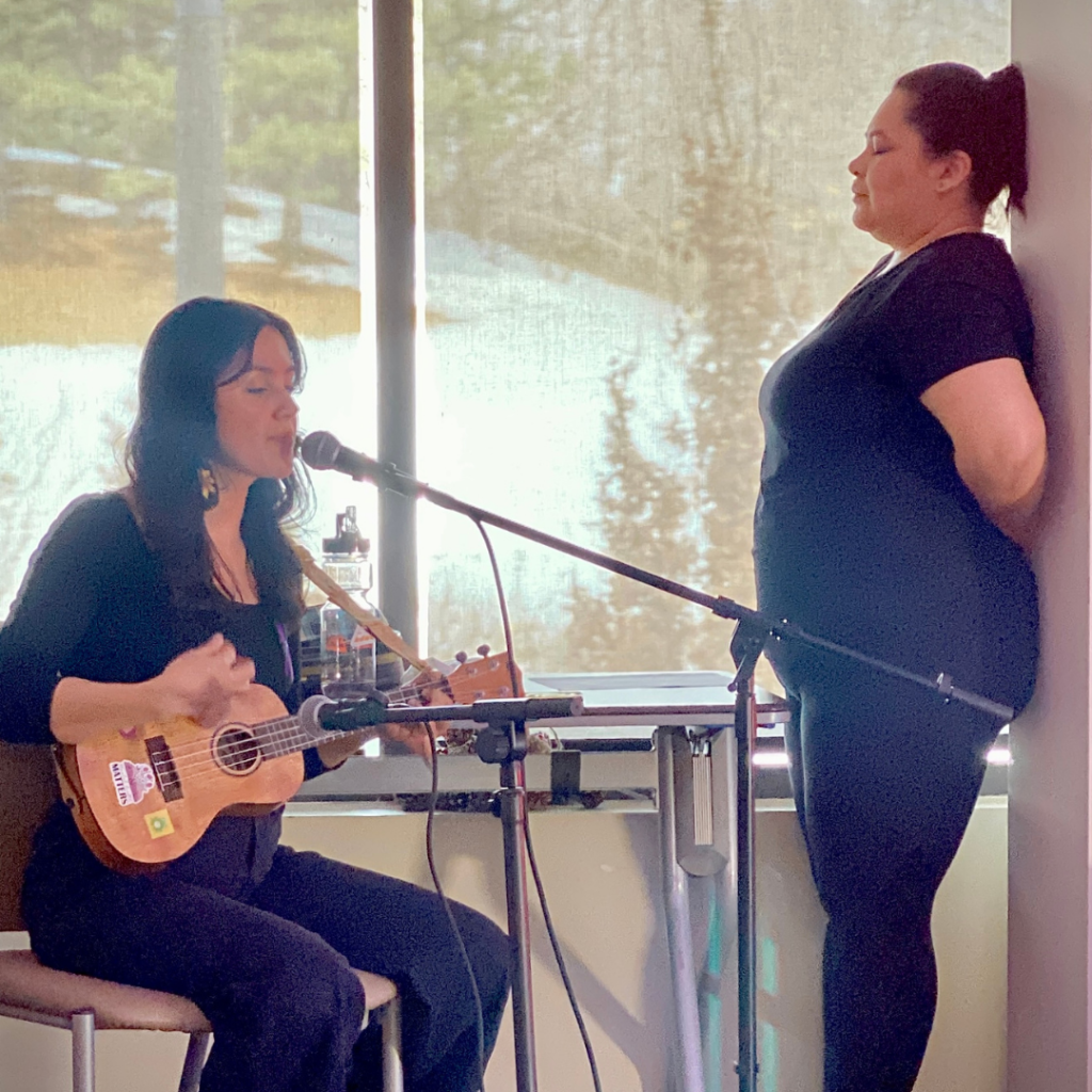 A woman playing the ukulele.